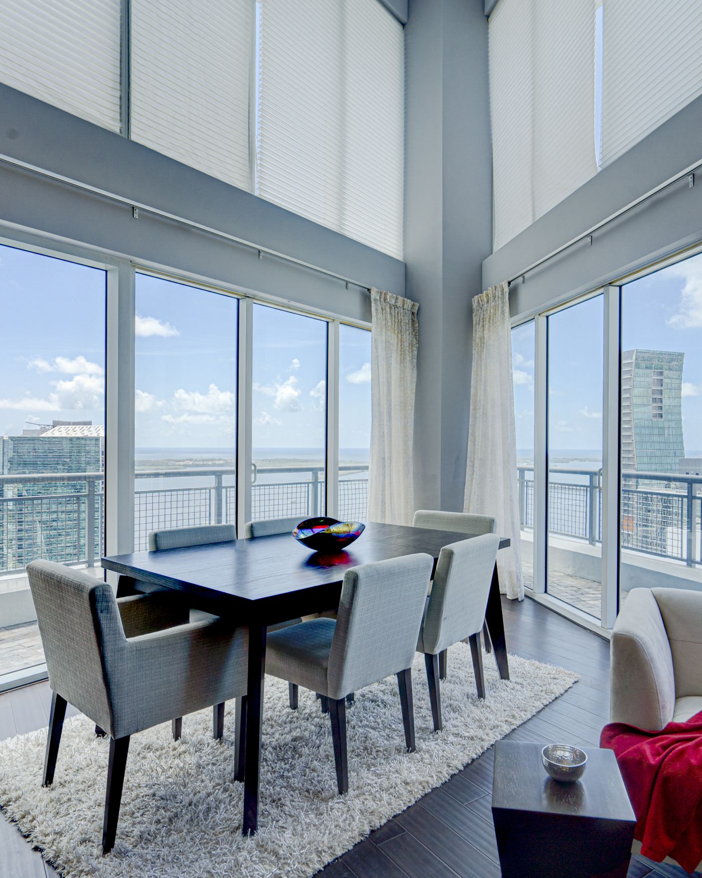 Brickell penthouse dining room with floor-to-ceiling windows and panoramic Miami skyline view — Coronado Photo & Media