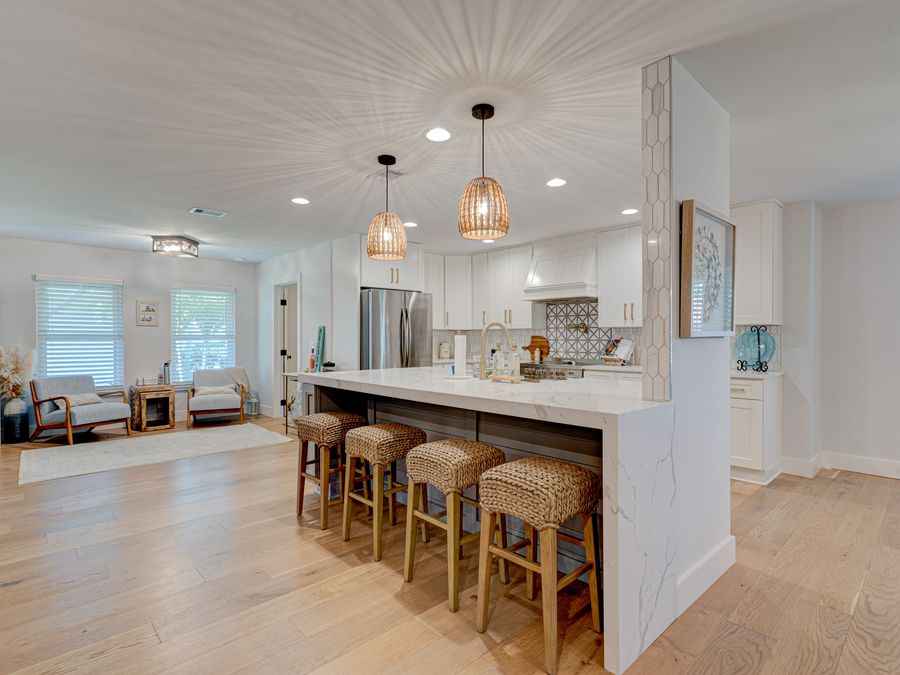 Coral Gables open concept kitchen with marble island and bar stools
