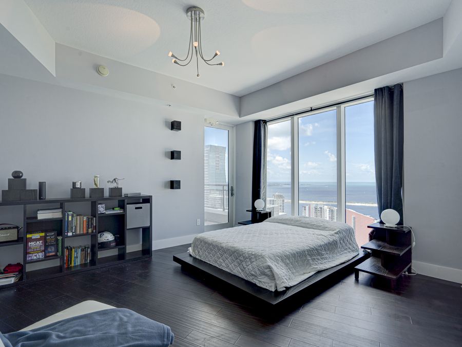 Brickell penthouse bedroom with panoramic ocean view through floor-to-ceiling windows